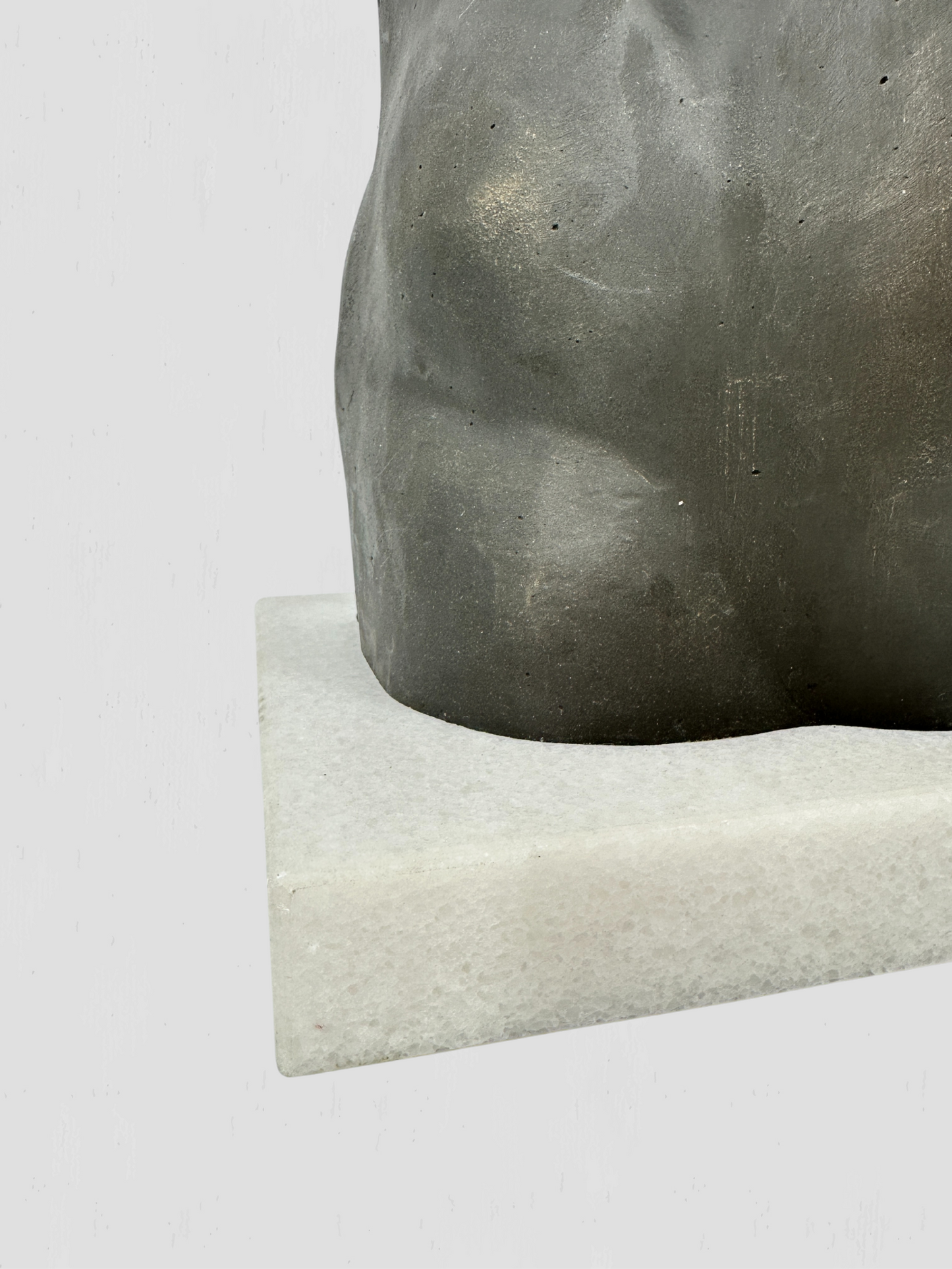 Black Metal Torso Sculpture on White Marble Base